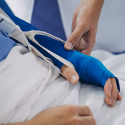 Doctor holding the bandaged hand of a personal injury victim