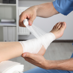 Medical professional wrapping gauze around a personal injury victim’s foot